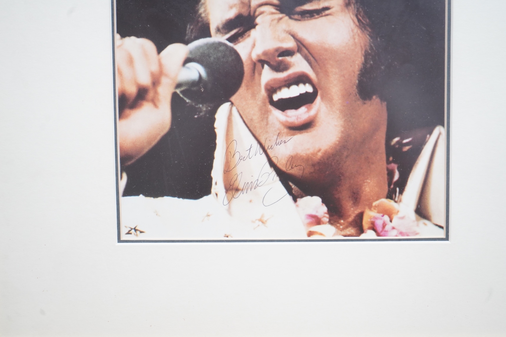 A framed signed photograph of Elvis Presley from his Hawaii show, signed; ‘Best Wishes, Elvis Presley’, originally retailed by Fraser’s, with a certificate of authenticity to the reverse, sold without further provenance,
